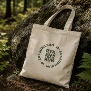Naturfärgad tygkasse med Rya Åsar Trail Runs jubileumsmärke.